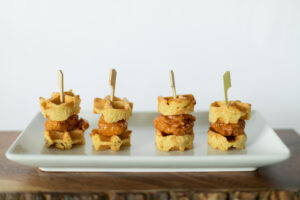 Made by Meg Catering Tray Passed Appetizer Chicken & Waffle Sliders on white plate with tooth pick 