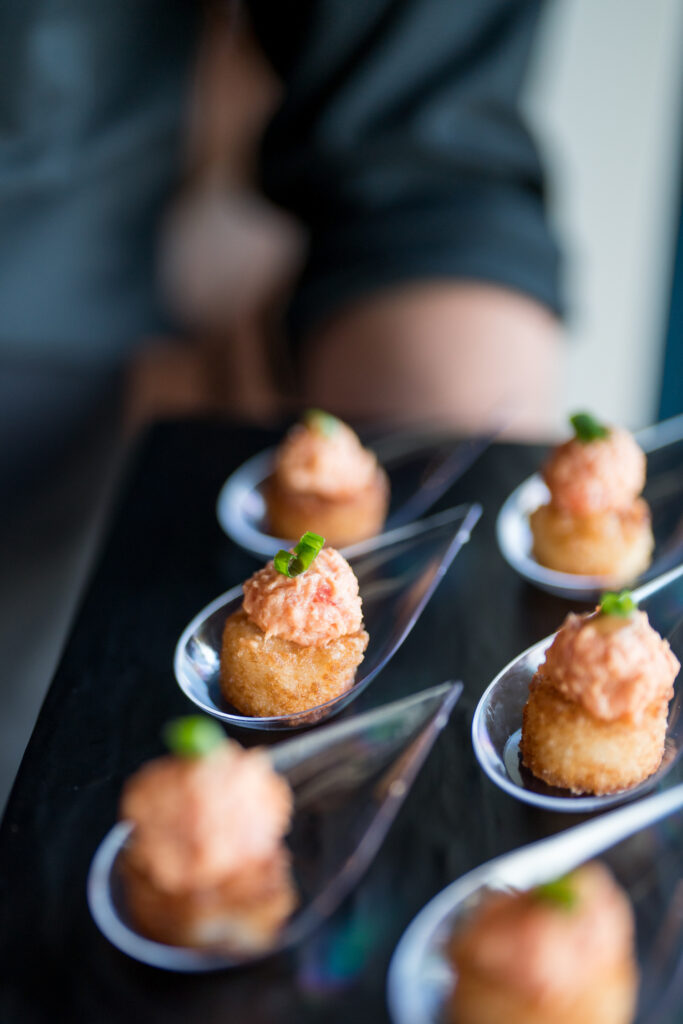 Spicy Tuna on Crispy Rice Being Passed on a black tray at Cocktail Hour Wedding Reception