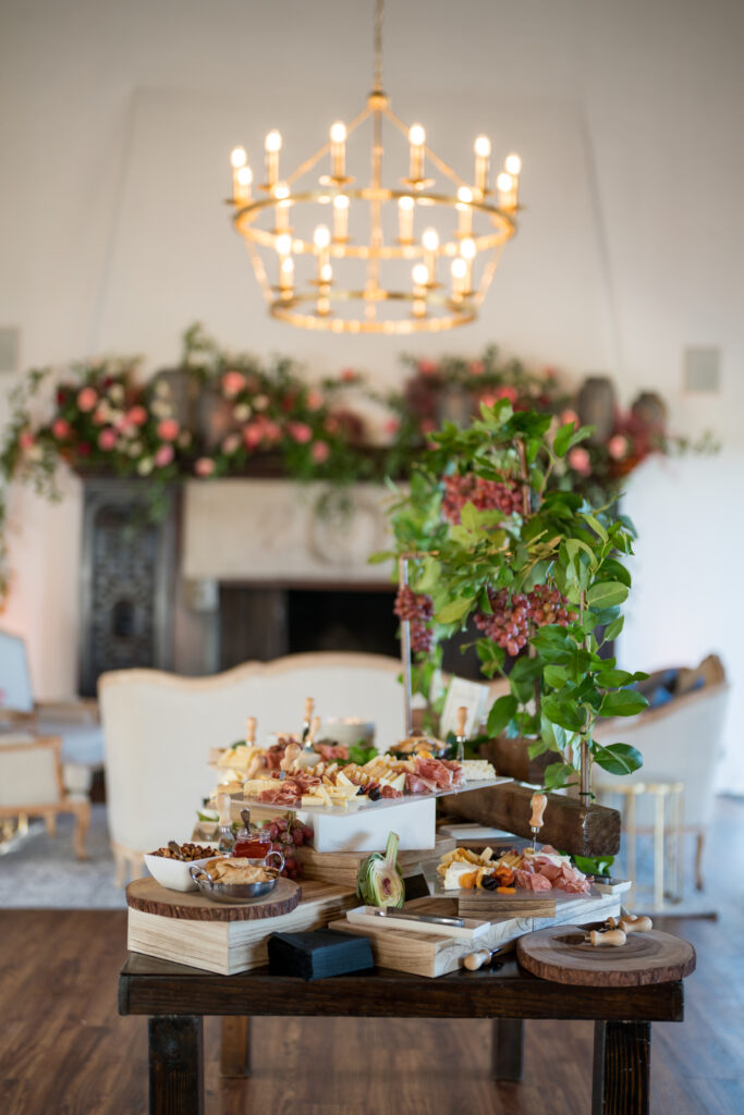 Cheese and Charcuterie Board at Cocktail Hour Wedding Reception at la Venta Under Chandelier 