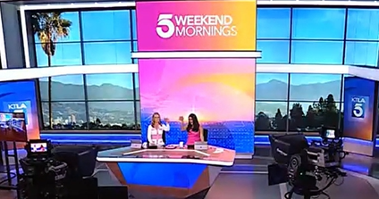 Screenshot of KTLA Memorial Day segment featuring with two anchors doing a cheers in front of the KTLA Weekend Morning screen with the Watermelon Mint Refresher mocktail in glass cups with fresh watermelon juice, watermelon chunks, fresh squeezed lime juice, house made mint syrup, fresh mint leaves, and soda water