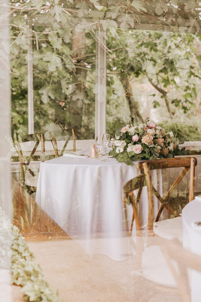 Outside View of Wedding Sweetheart Table Through the Glass at La Venta Inn