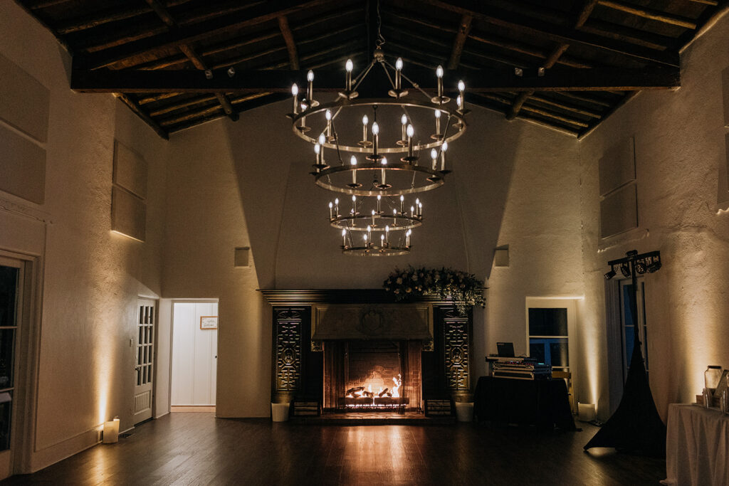 La Venta Inn Wedding Ballroom with Two Chandeliers and Hardwood Flooring and a Fireplace