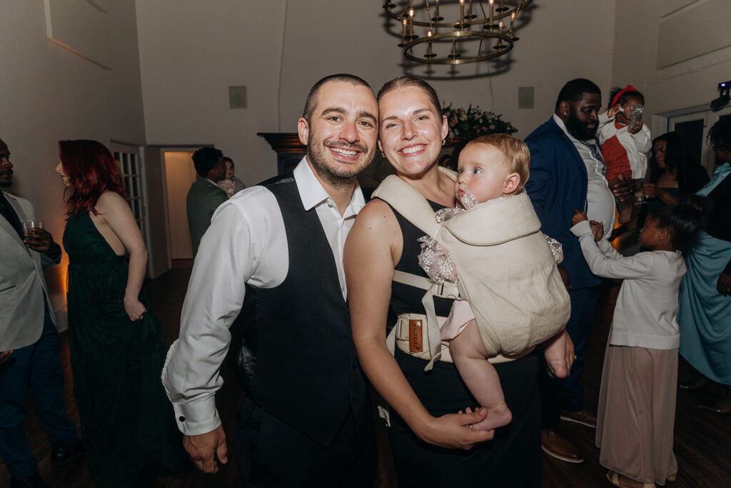 Couple Dancing with Baby at Wedding