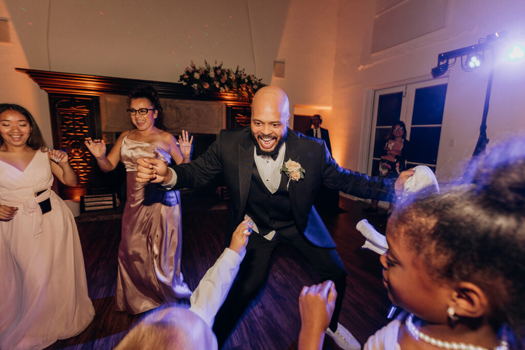 Groom Dancing With Purple Lights at La Venta Inn Wedding 