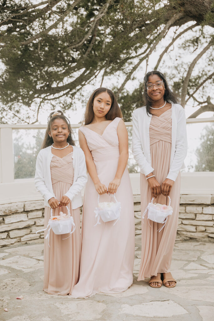 Flower Girls Posing Together With Their Flower Baskets