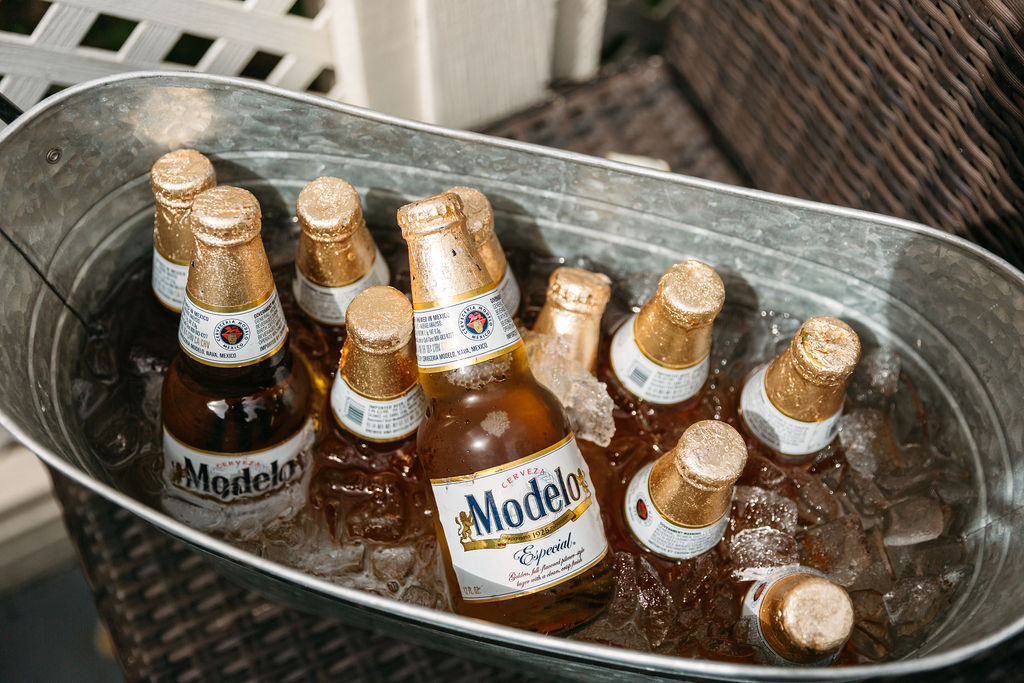 A close up shot of iced Modelos in a silver container.