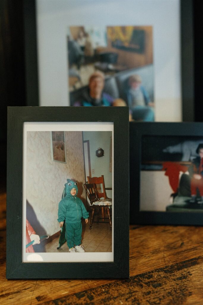 Pictures of photo frames as present ideas. The frame contains a kid wearing a dinosaur costume.