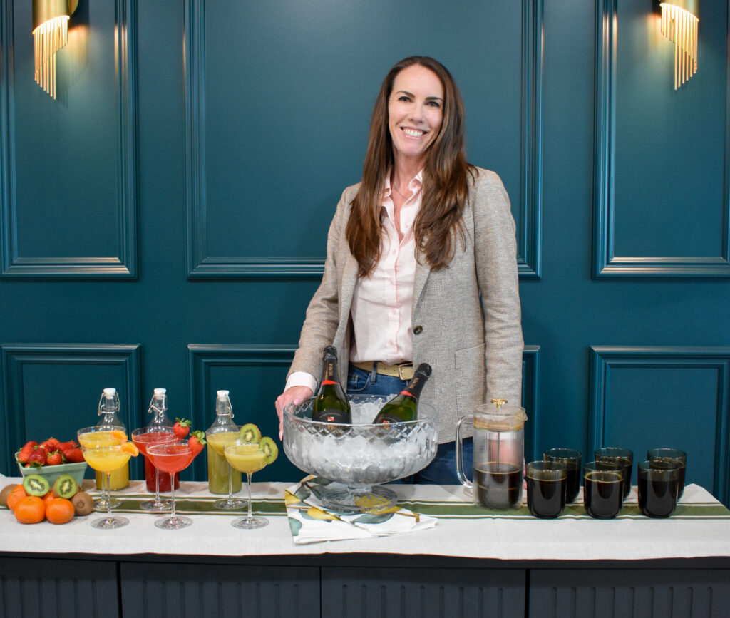 Six coffee mugs and six Long-Stem Champagne Coupe Glasses filled with different mimosas with different juices: freshly squeezed tangerine juice, strawberry juice, and kiwi juice