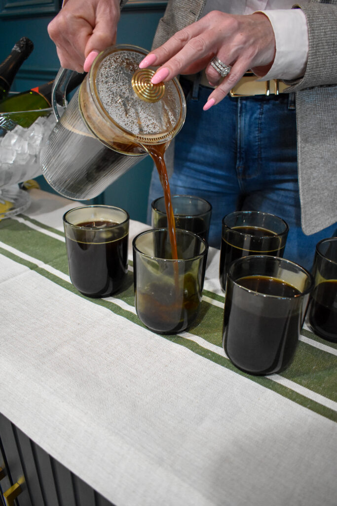 French Press Coffee Brewer being poured into 6 green Fellow Pirch Woodland 11-oz. Latte Mugs